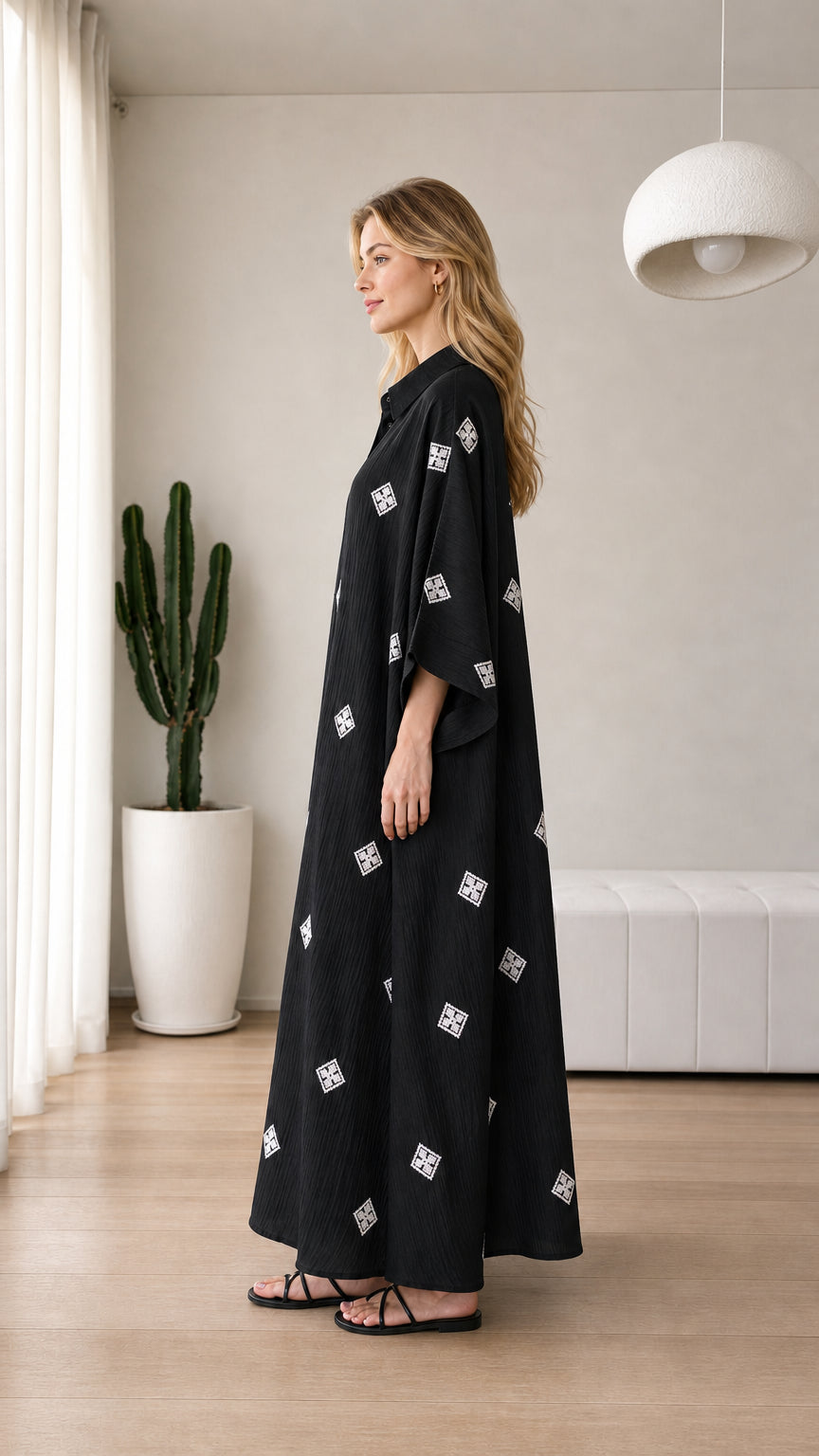 Side view of black loose-fit maxi kaftan dress with wide sleeves