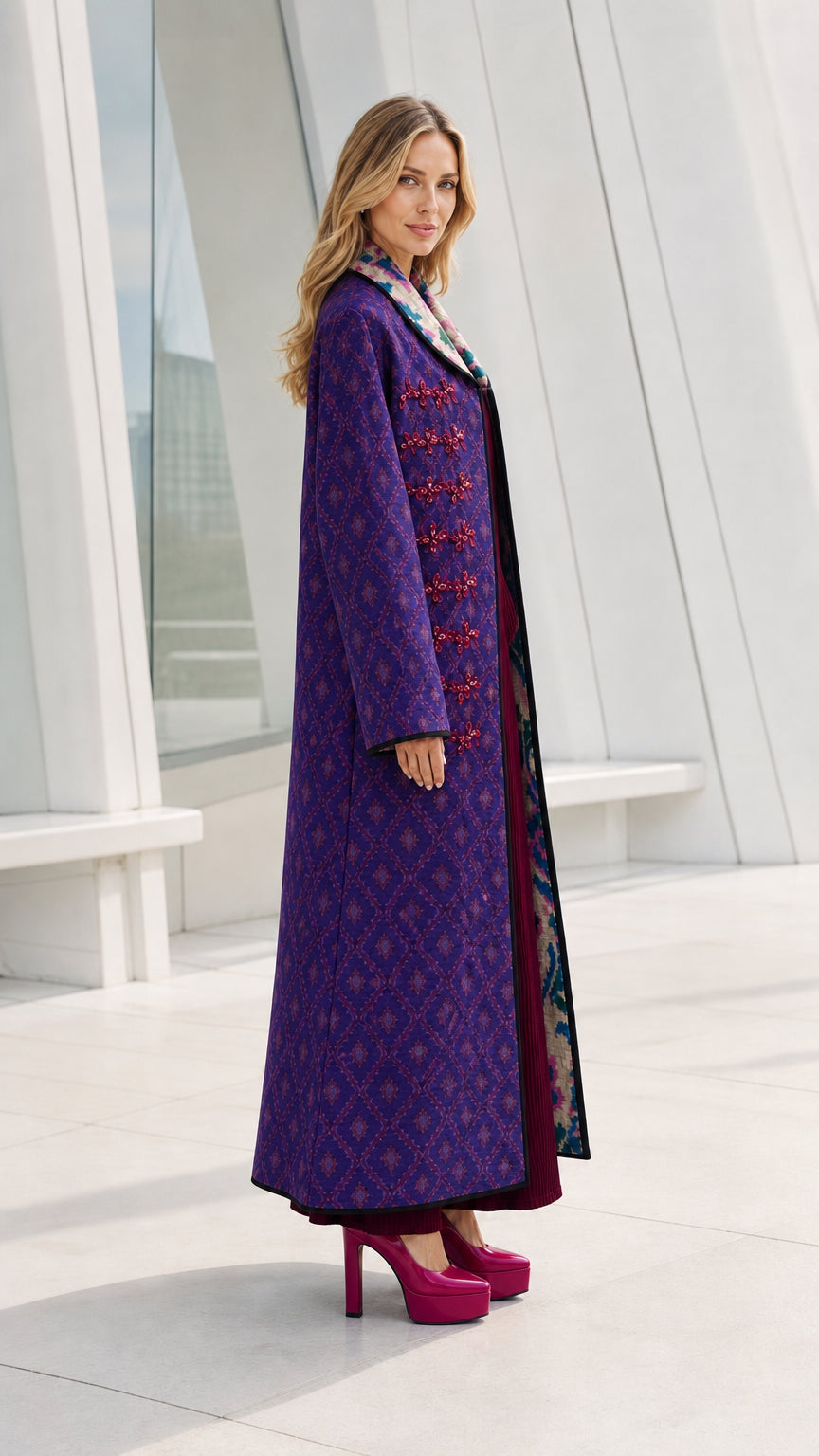 Side profile view of model in purple long coat