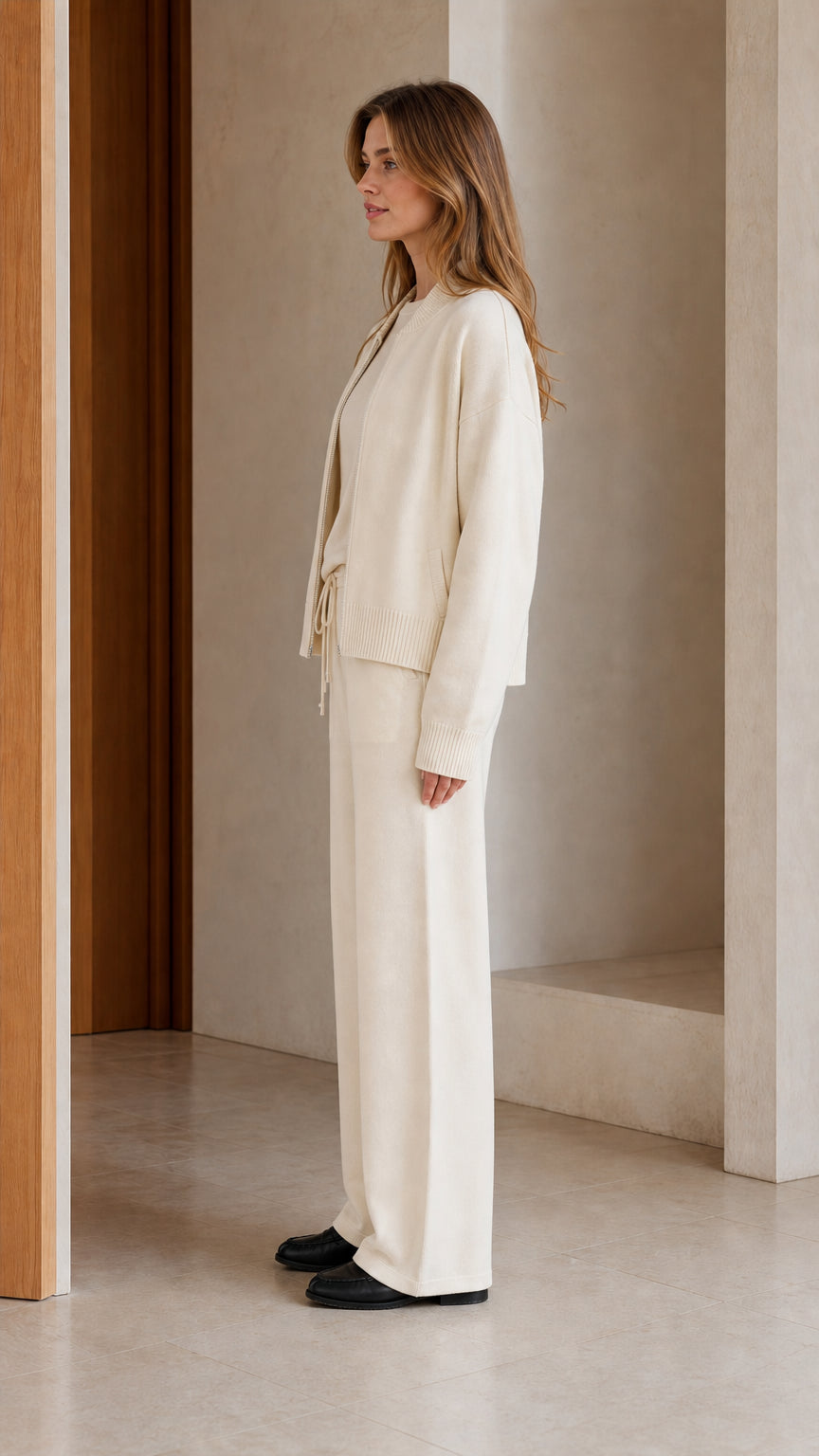 Side view of model wearing cream monochrome 3-piece knit matching set