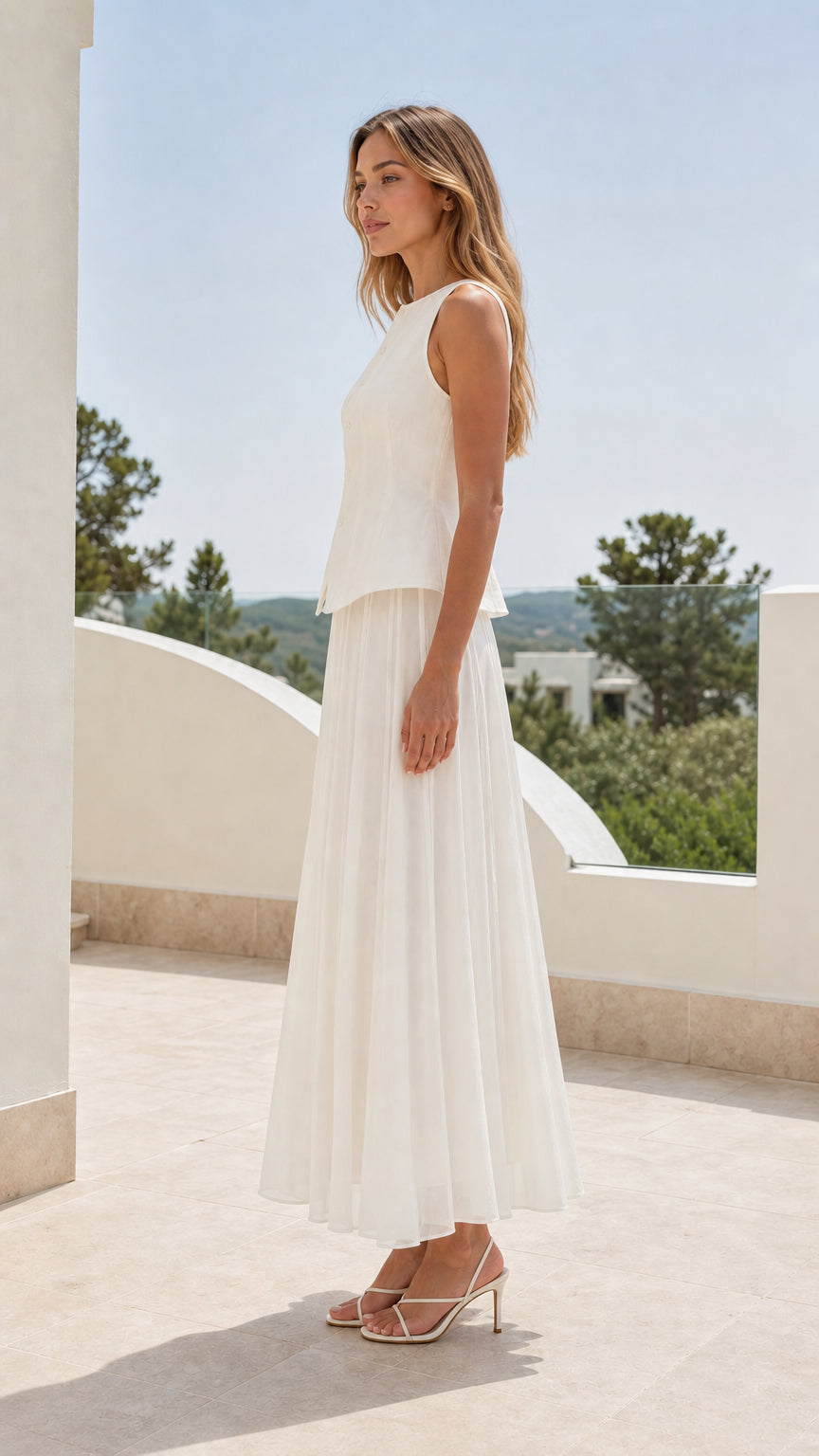Side profile view of woman in white matching top and skirt set