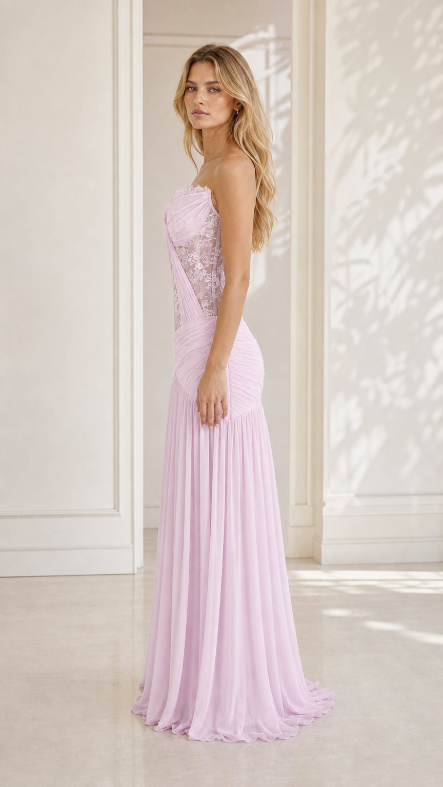Model wearing lavender strapless lace evening dress, side profile