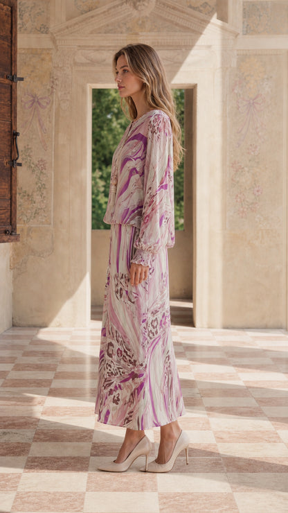 Side profile of model in pink abstract maxi dress