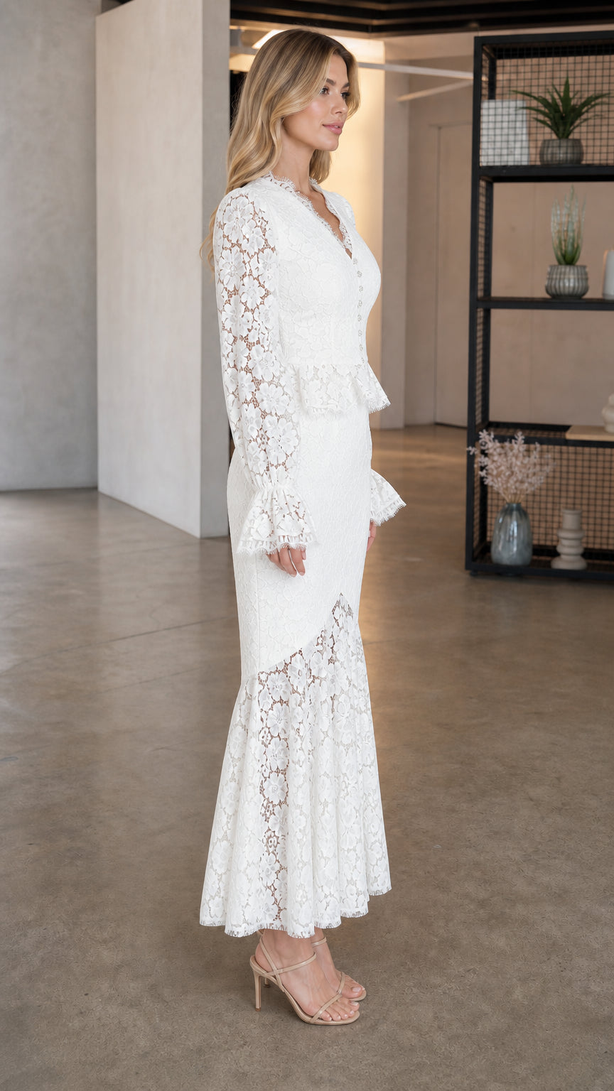Side profile of model in white lace dress