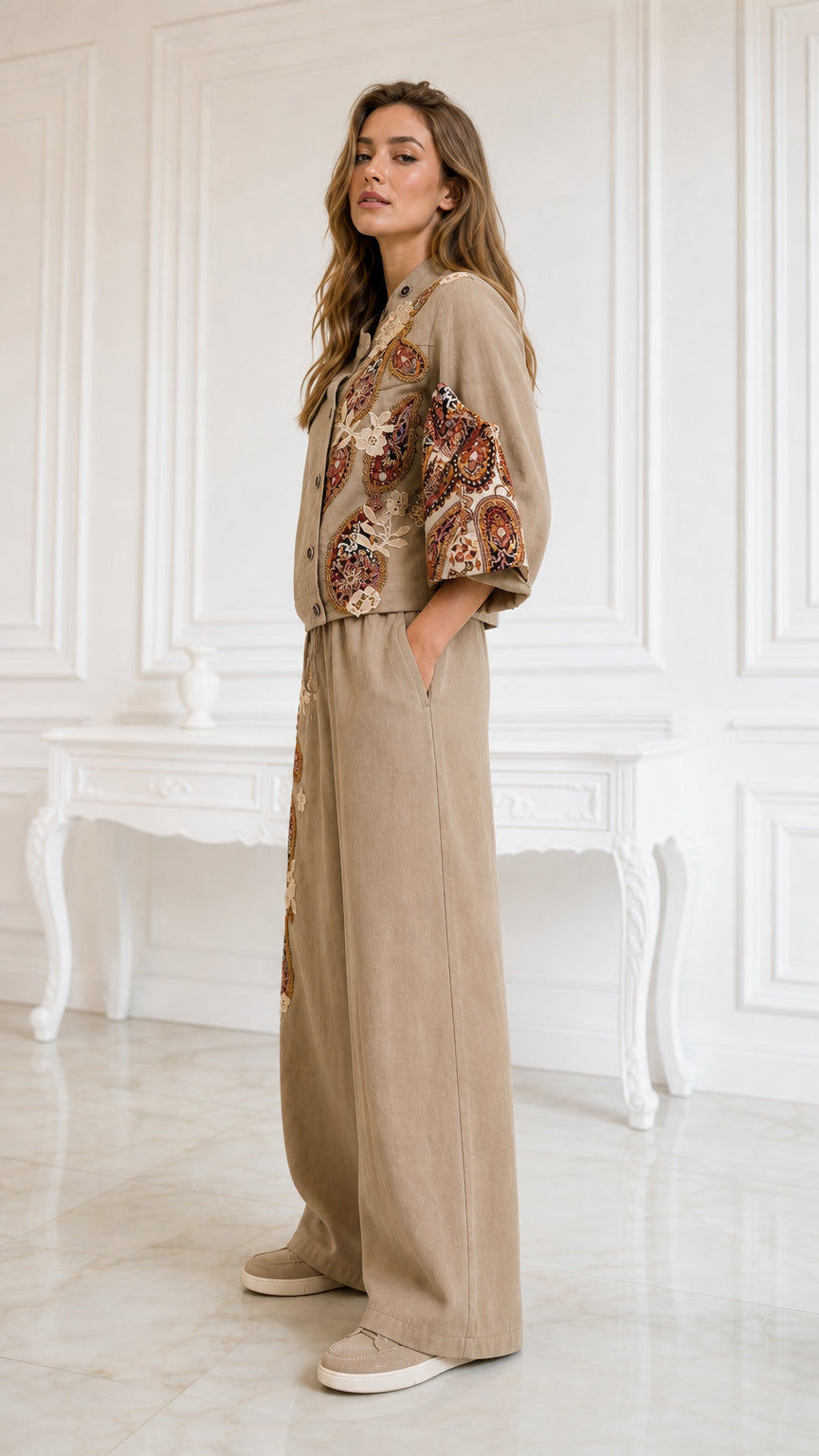 Side profile view of model in khaki embroidered two-piece wide-leg set