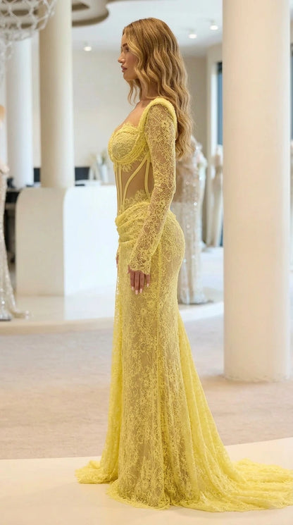 Side profile view of yellow lace evening gown with train