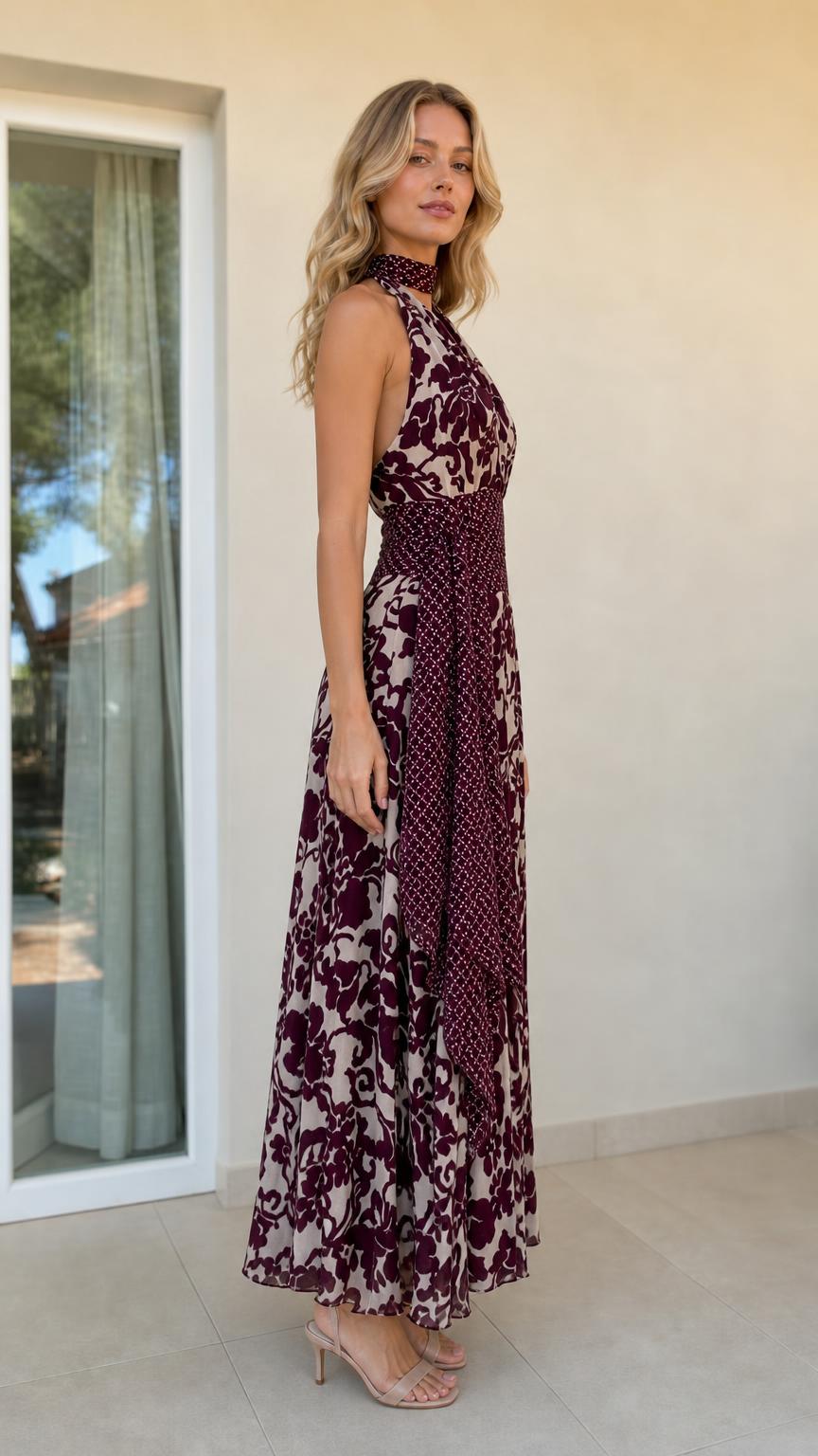 Side profile view of burgundy halter maxi dress