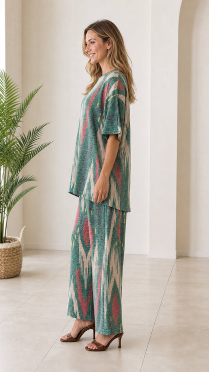 Side profile of woman in green bohemian ikat printed two piece pant set