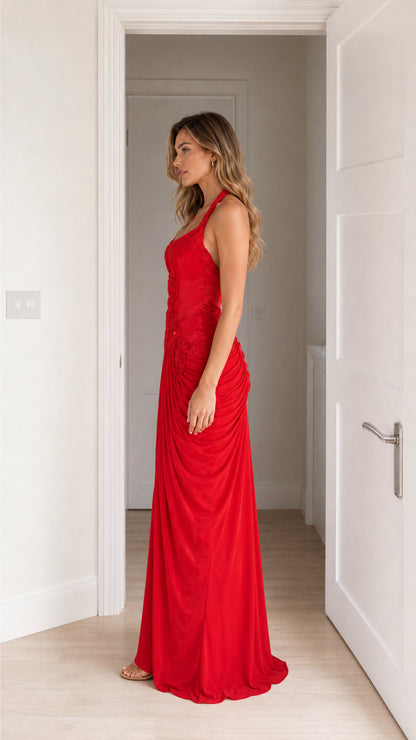 Side view of model in red halter neck maxi dress
