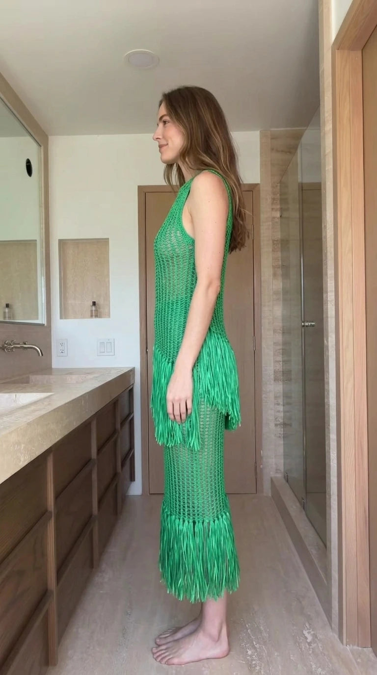Side view of woman wearing green open-knit fringe midi dress