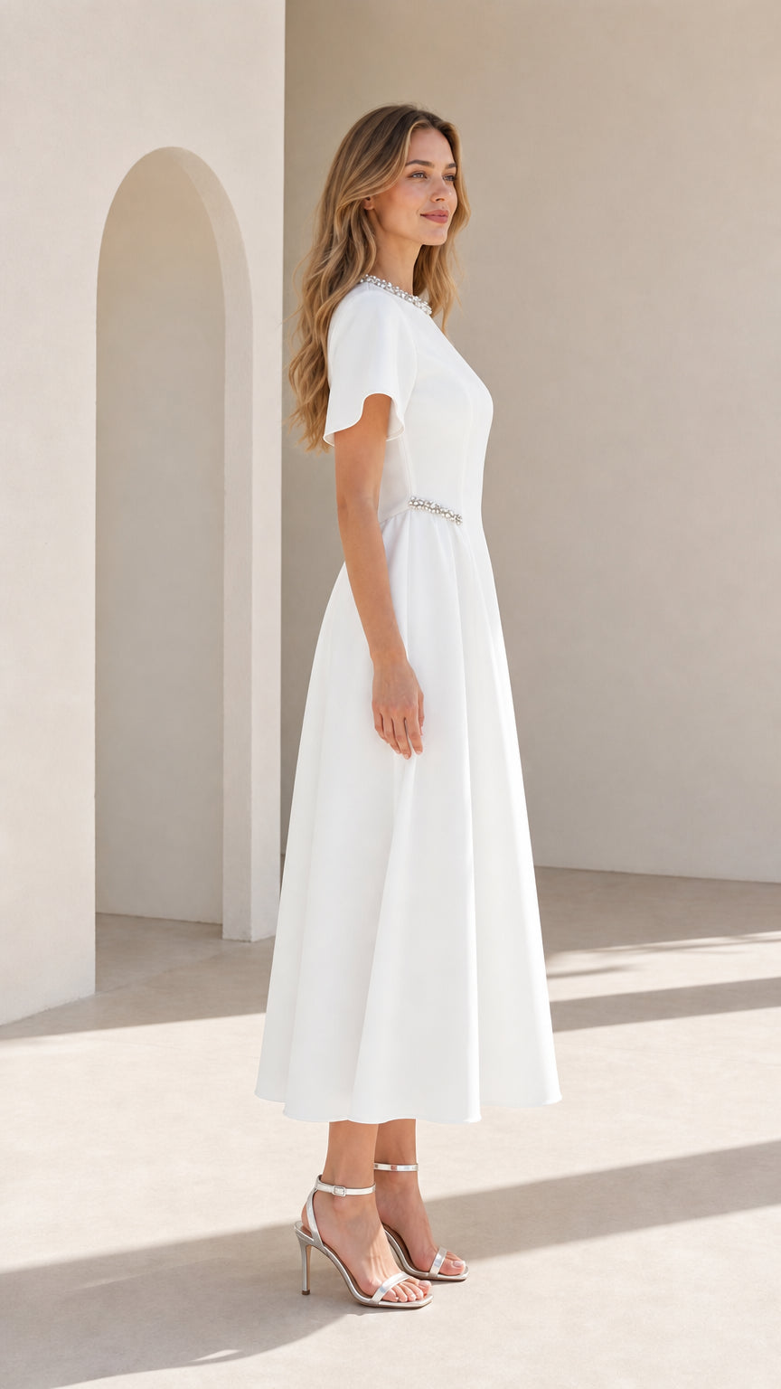 Side profile view of woman wearing white A-line midi formal dress