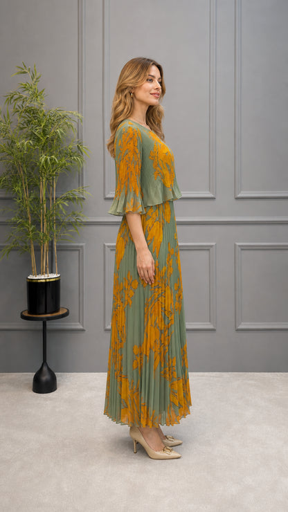 Side profile view of sage green floral pleated maxi dress showing sleeve and drape