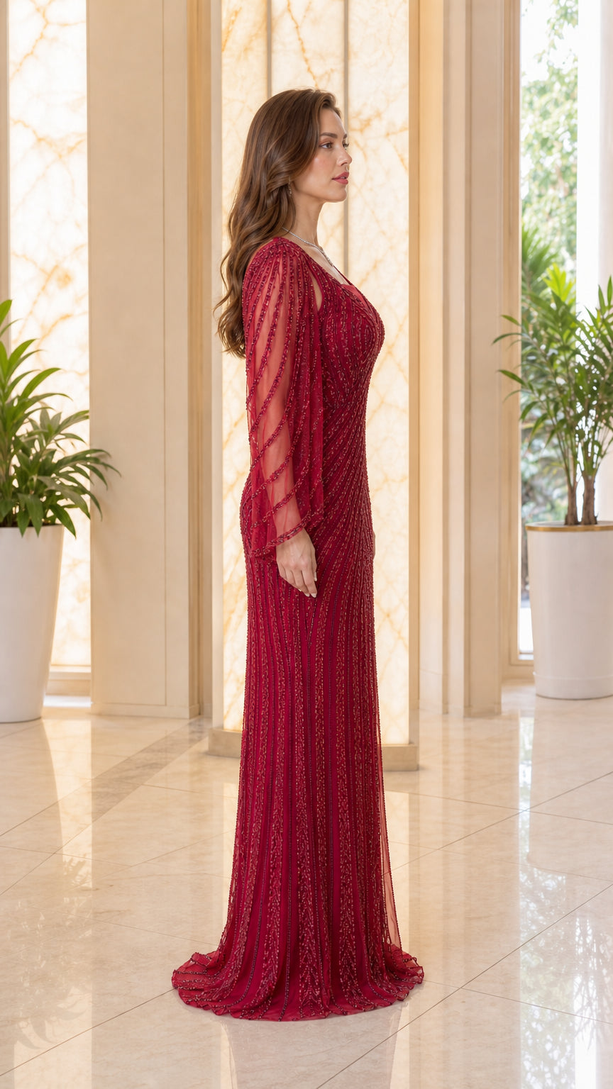 Side profile of model wearing burgundy sequin beaded evening dress