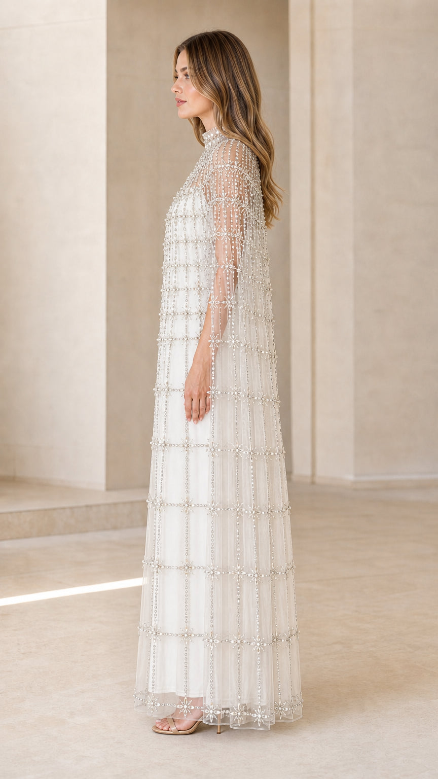 Side profile of model in Ivory White crystal-embellished cape maxi dress