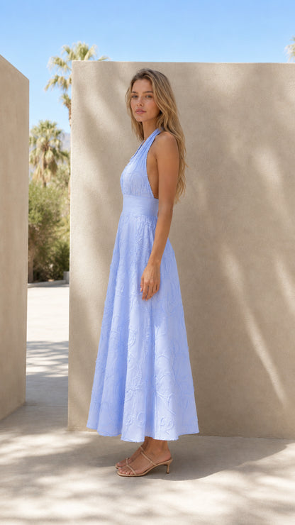 Side profile view of light blue halter maxi dress