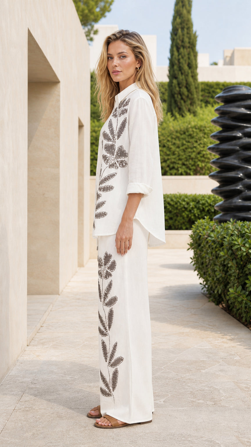 Side profile of woman in white embroidered matching set