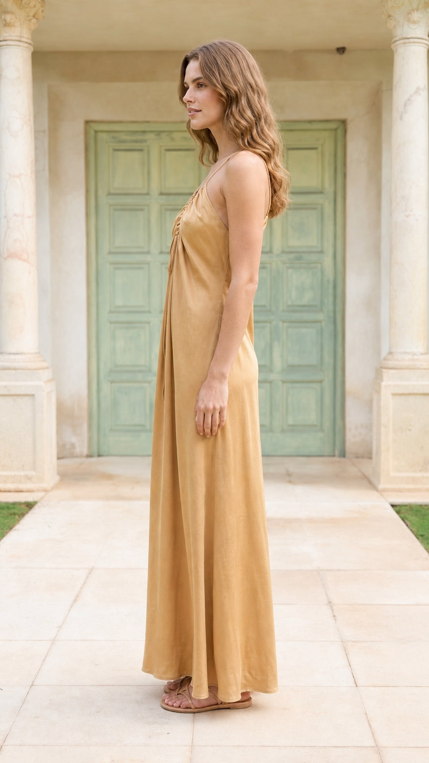 Side profile of model in champagne maxi dress
