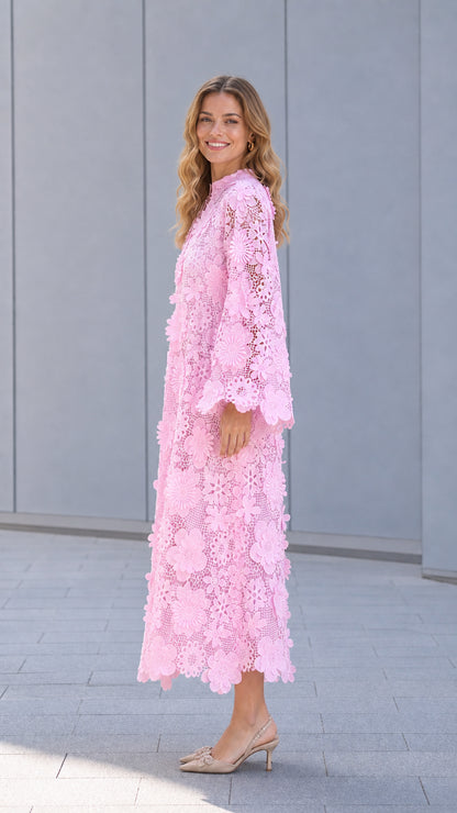 Side profile of model in pink lace dress