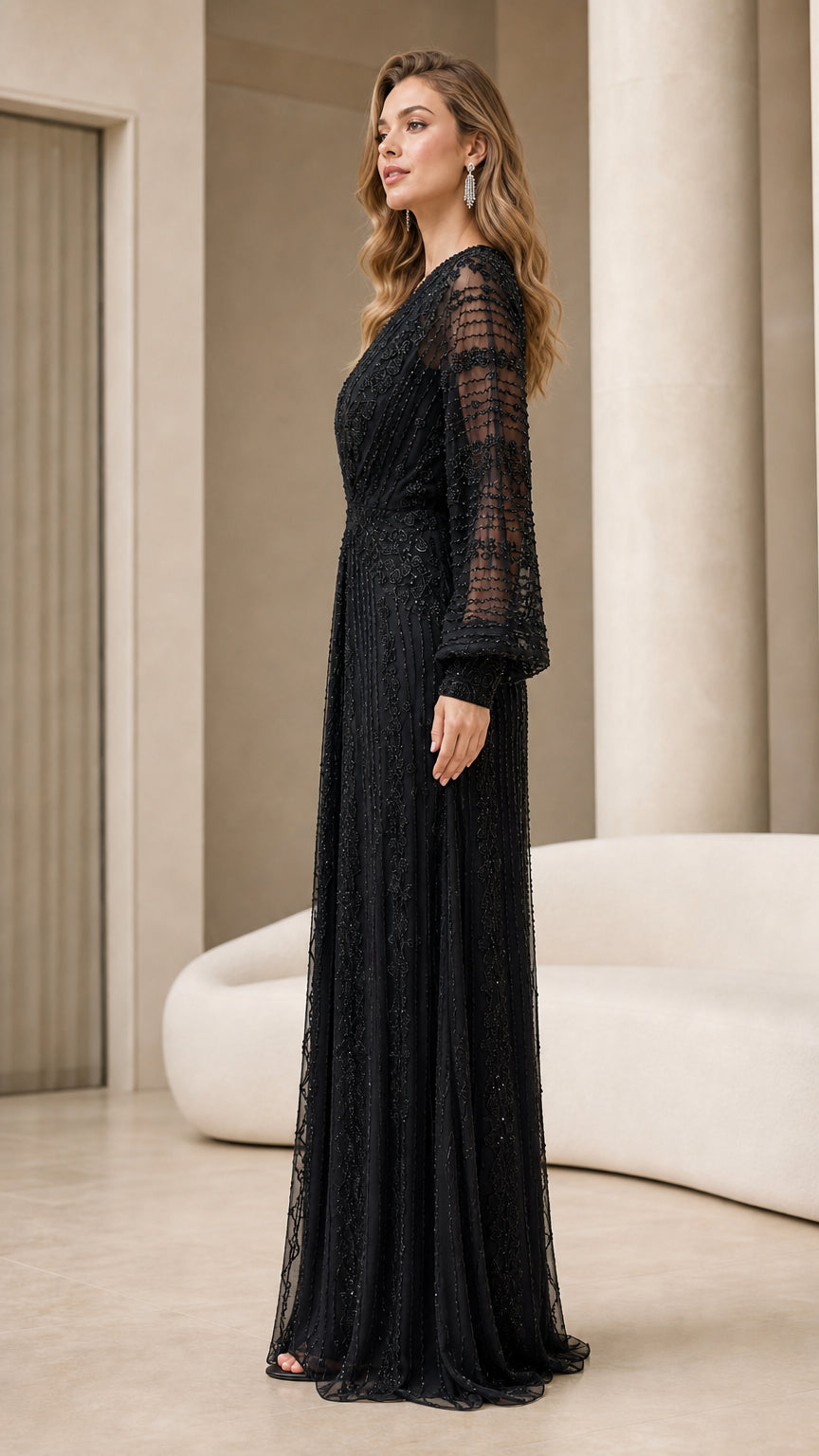 Side profile of woman in elegant black embellished long sleeve formal gown