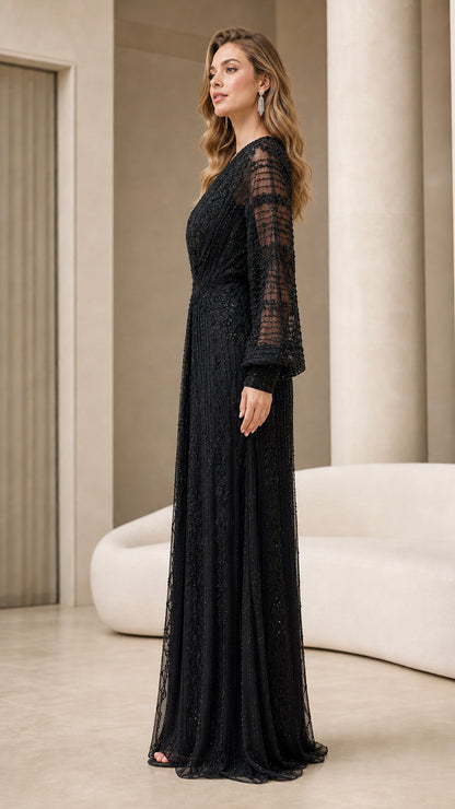 Side profile of woman in elegant black embellished long sleeve formal gown