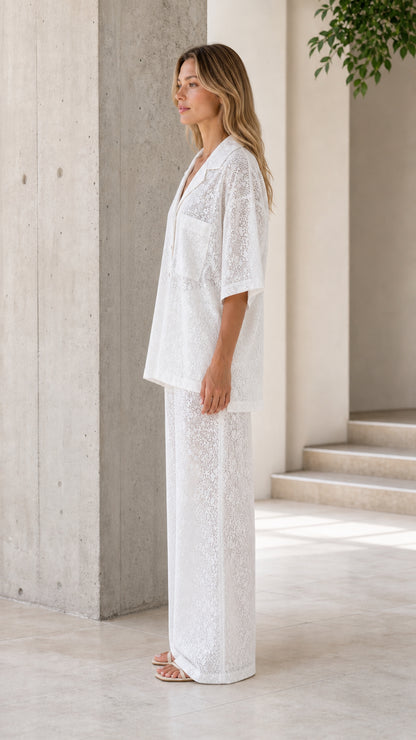 Side view of woman wearing white lace two-piece set