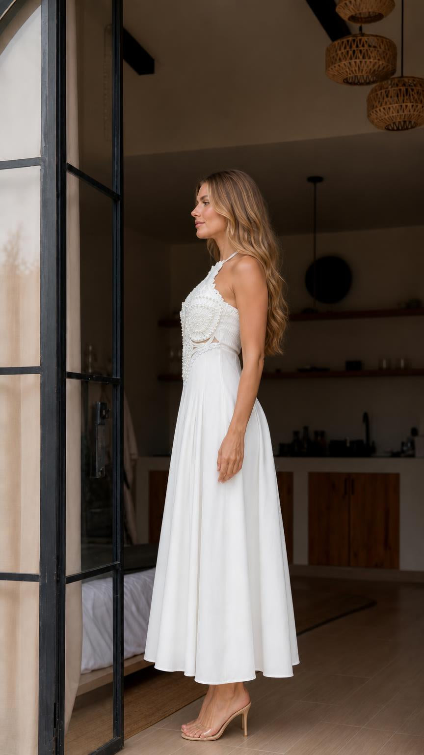 Side profile view of white halter maxi dress