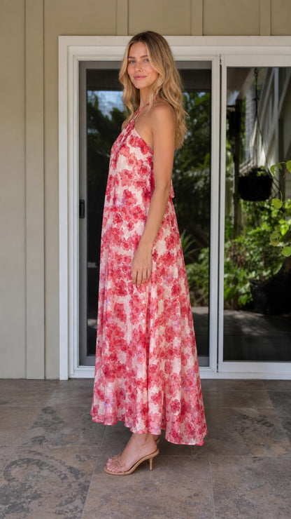 Side profile view of model in pink floral maxi dress