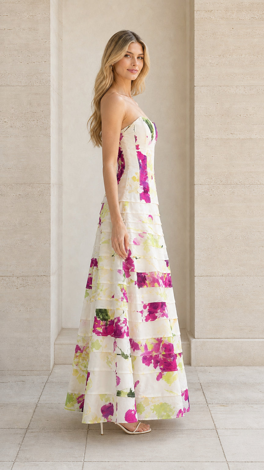 Side 3/4 view of ivory strapless watercolor floral tiered formal dress