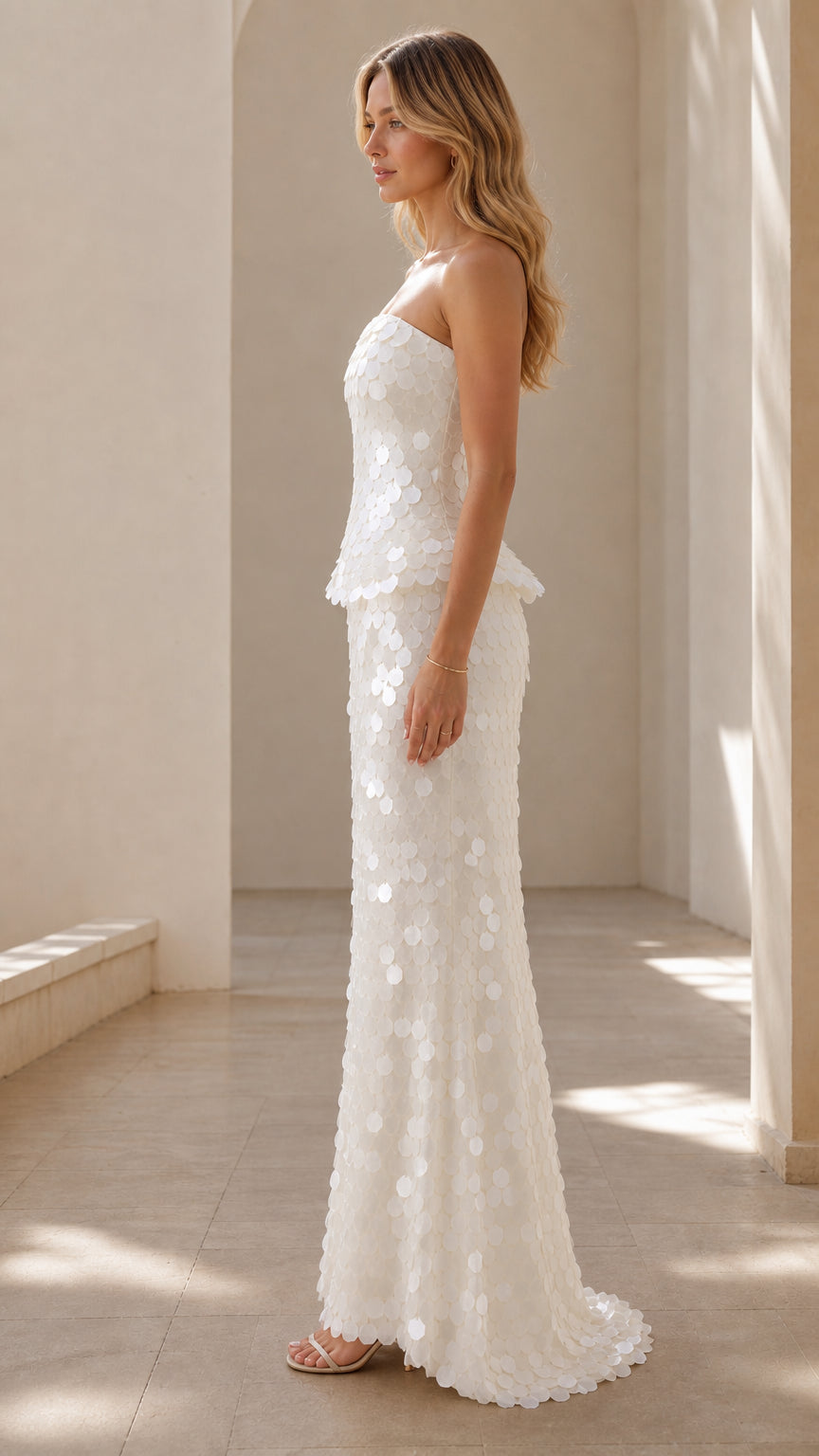 Side profile view of White strapless sequin gown