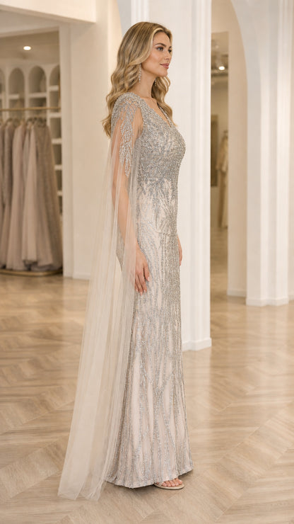 Side profile of Champagne Silver beaded evening dress showing floor-length flowing cape sleeves