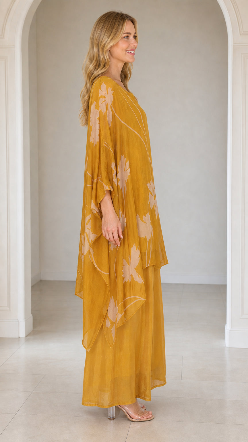 Side profile of woman in mustard yellow kaftan and pants