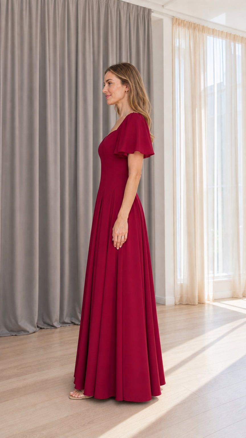 Side profile view of burgundy flutter sleeve maxi dress