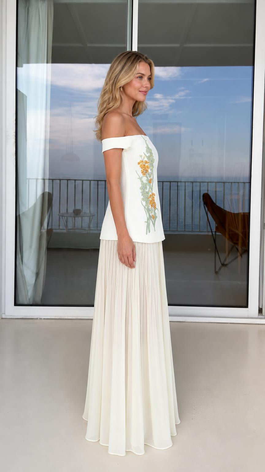 Side profile of model in white embroidered two-piece set