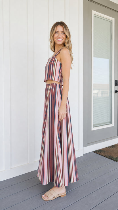 Side view of woman wearing pink striped two-piece set