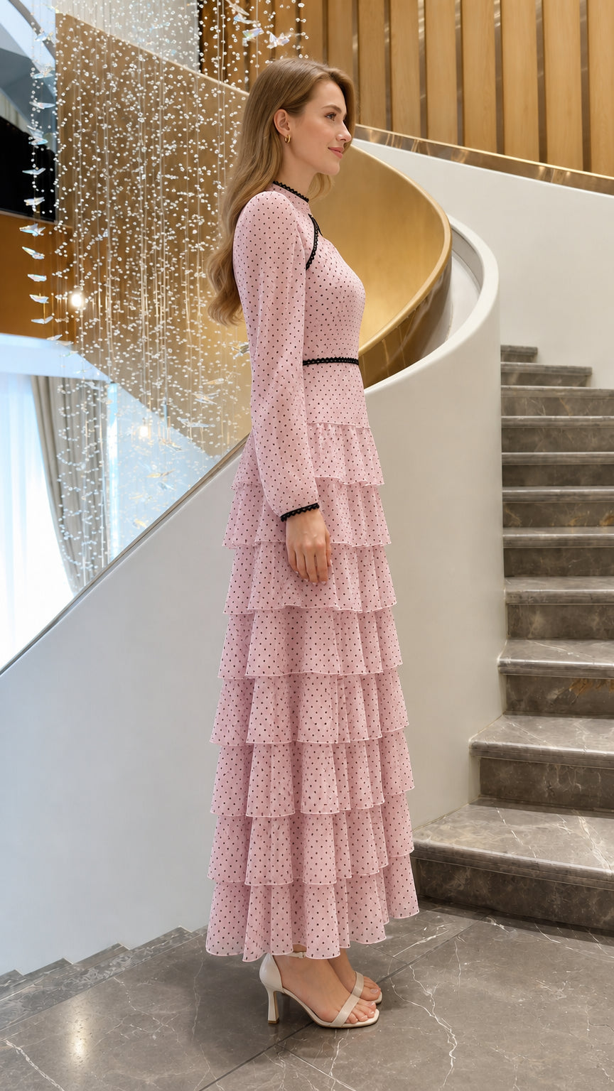 Side profile view of woman wearing blush pink polka dot long sleeve maxi dress
