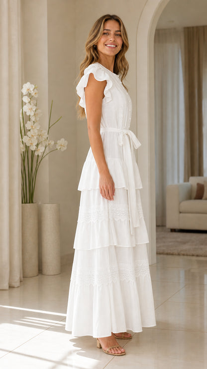 Side view of woman wearing white ruffle sleeve tiered maxi dress