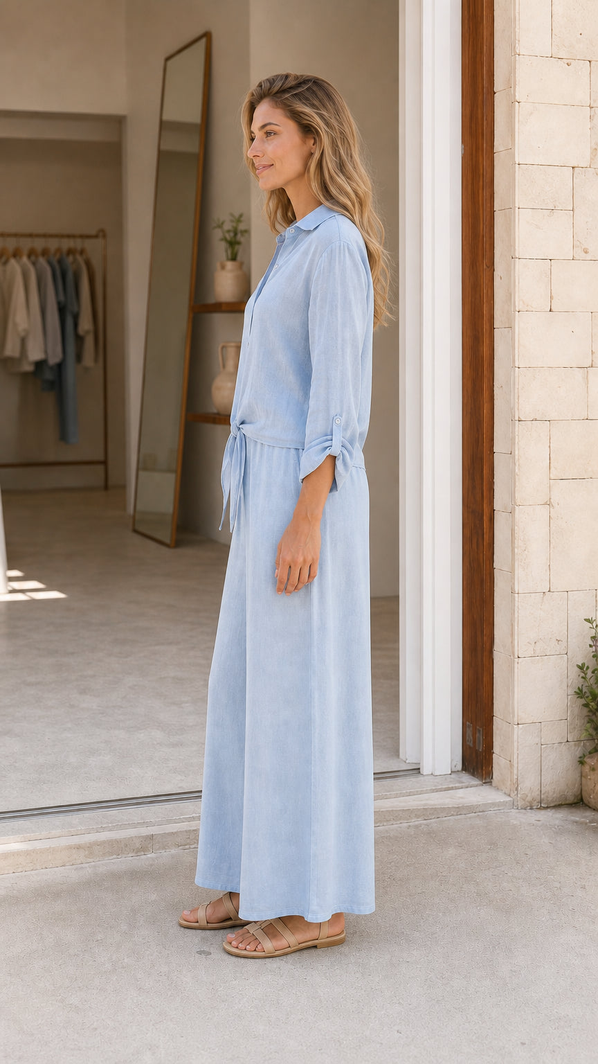 Side view of light blue button-down wide leg jumpsuit