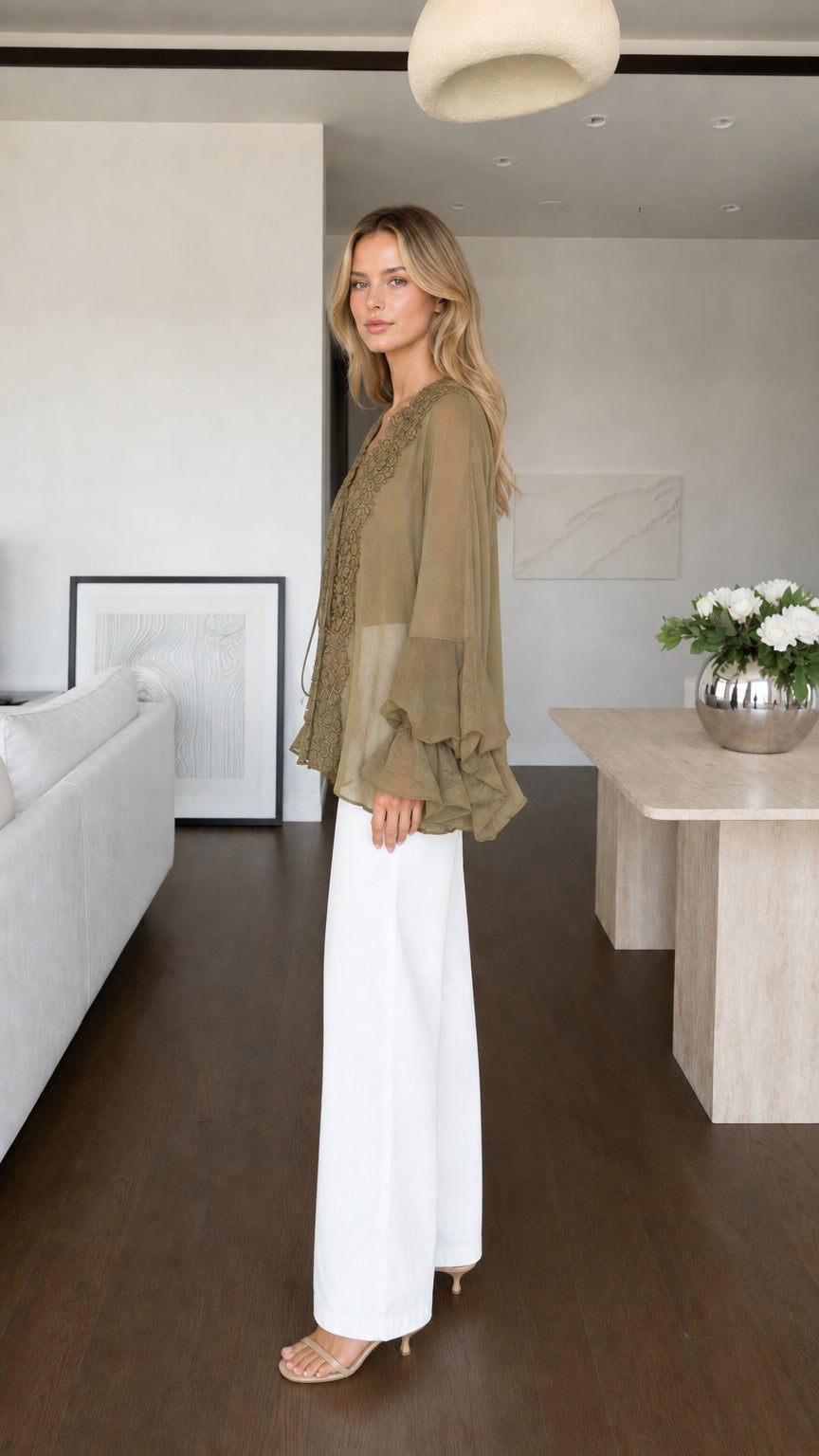 Model wearing olive blouse side profile view