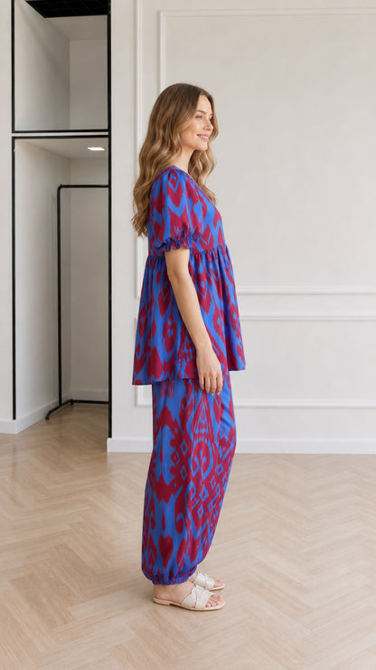 Side profile view of woman wearing Royal Blue printed two-piece set with puffed sleeves