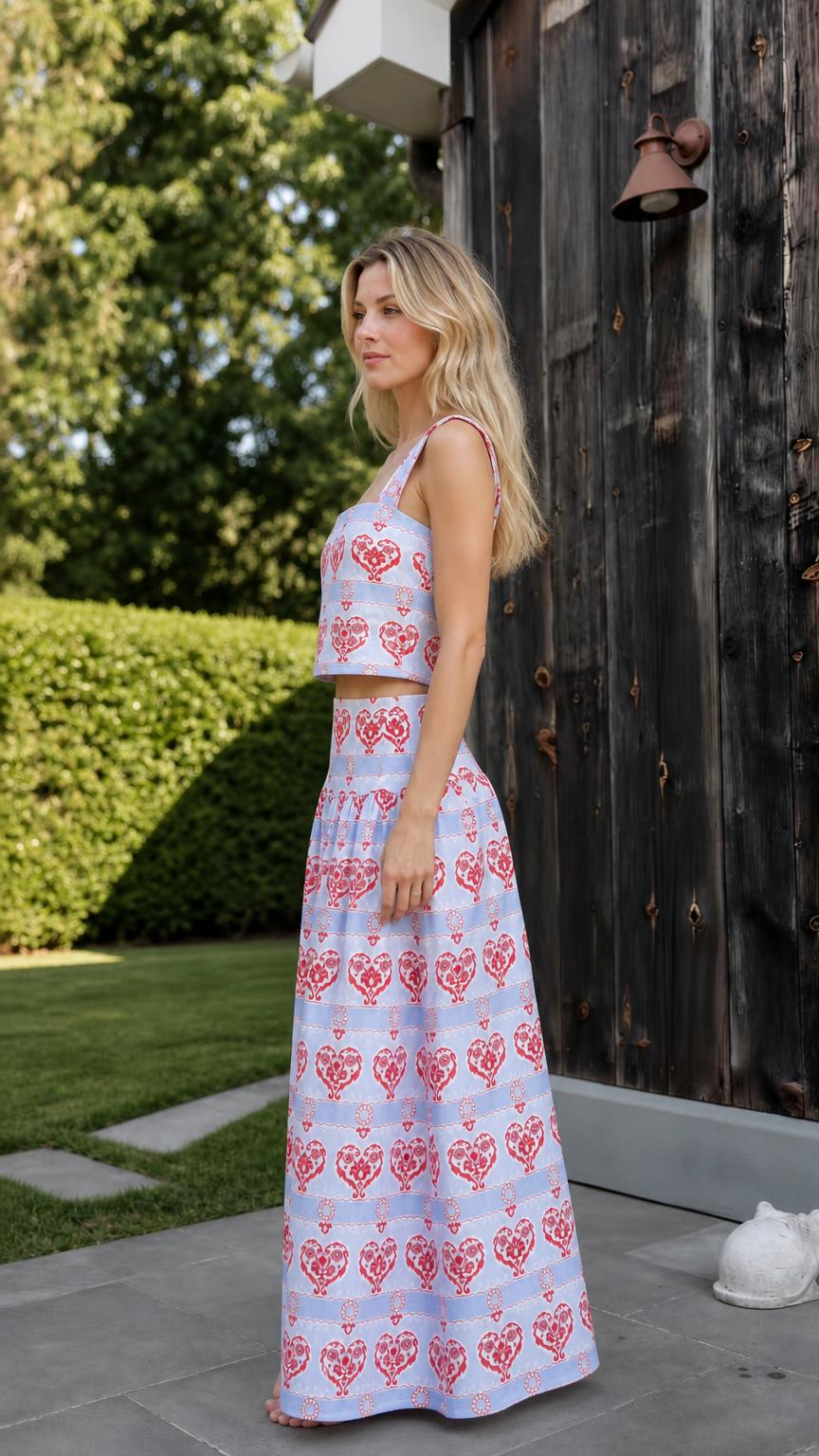 Side view of woman wearing light blue heart print two-piece set