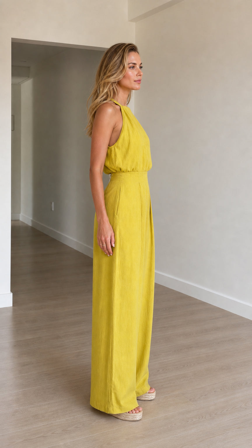Model wearing yellow jumpsuit side profile view