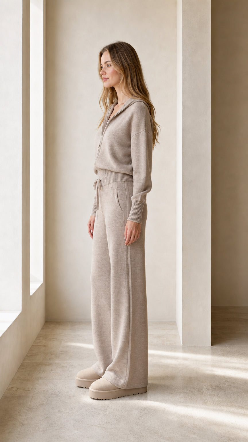 Side view of the taupe hooded sweatshirt and matching wide-leg pants