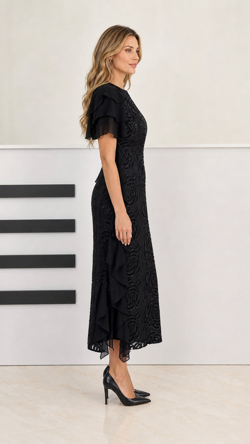 Side profile of model in black beaded midi dress