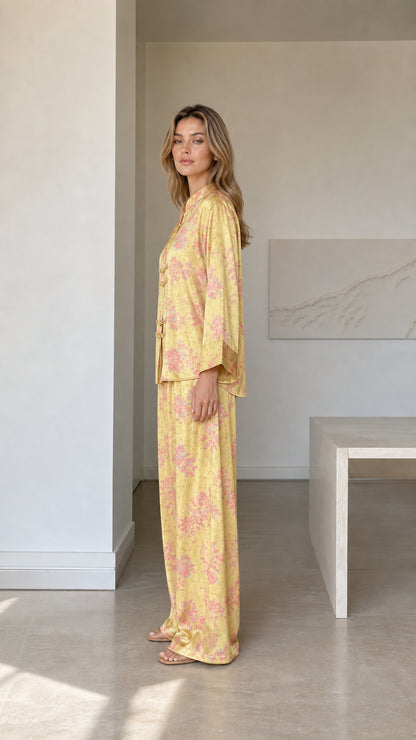 Side profile view of yellow satin floral two-piece loungewear set