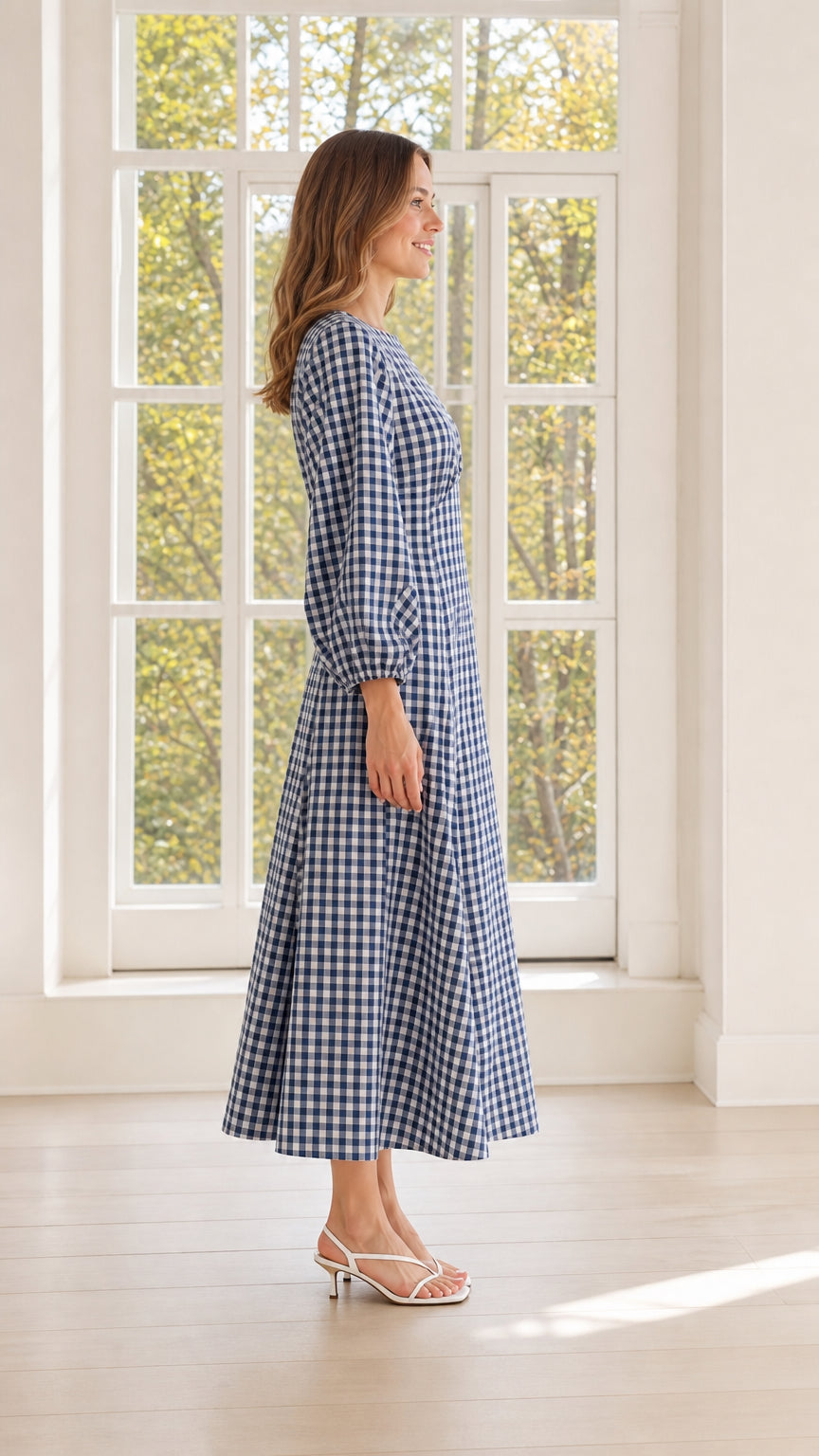 Side view of woman wearing blue gingham midi dress