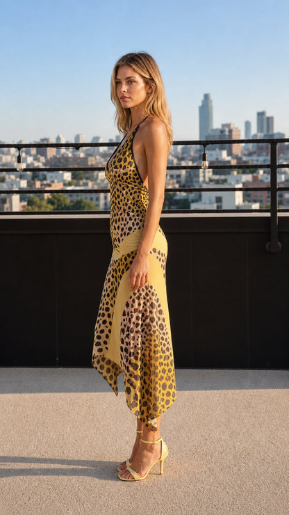 Side profile of model in yellow leopard print midi dress on rooftop