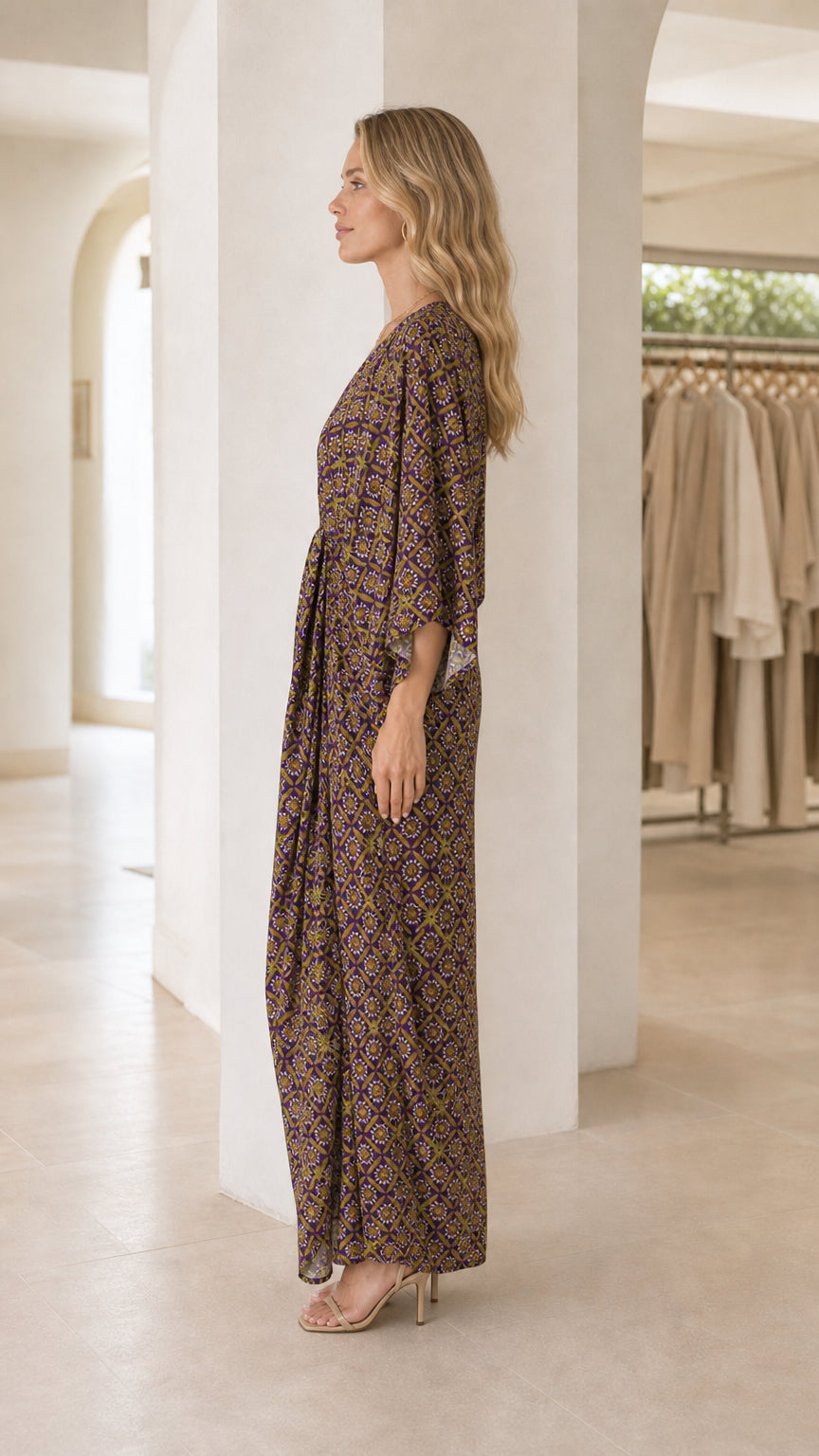 Model wearing purple printed maxi dress from the side profile