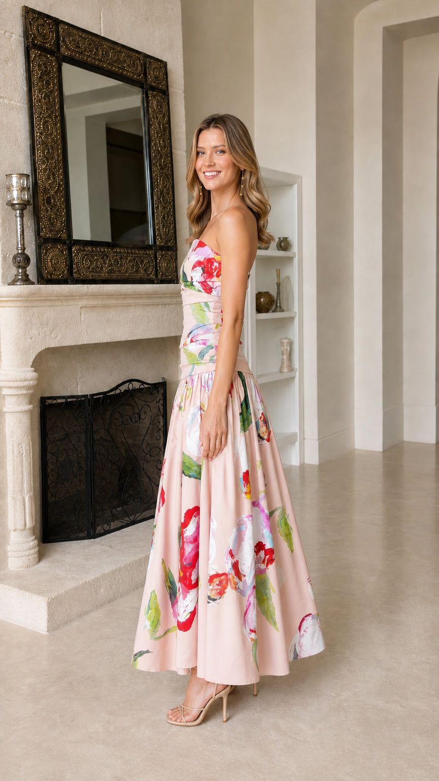 Side profile of model in pink floral strapless maxi dress