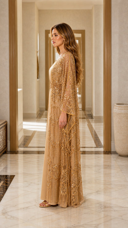 Side profile of gold sequin cape maxi dress