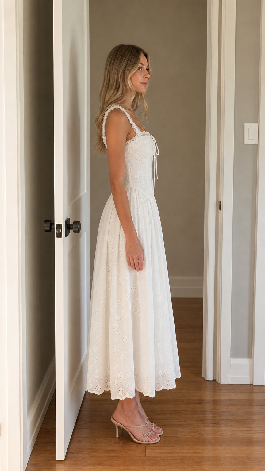 Side view of woman wearing white square neck eyelet midi dress