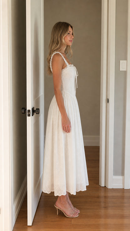 Side view of woman wearing white square neck eyelet midi dress